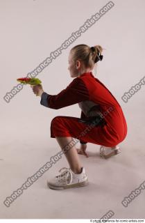 DENISA SITTING POSE WITH GUN